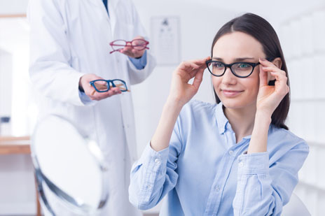 Women trying eyeglass frames